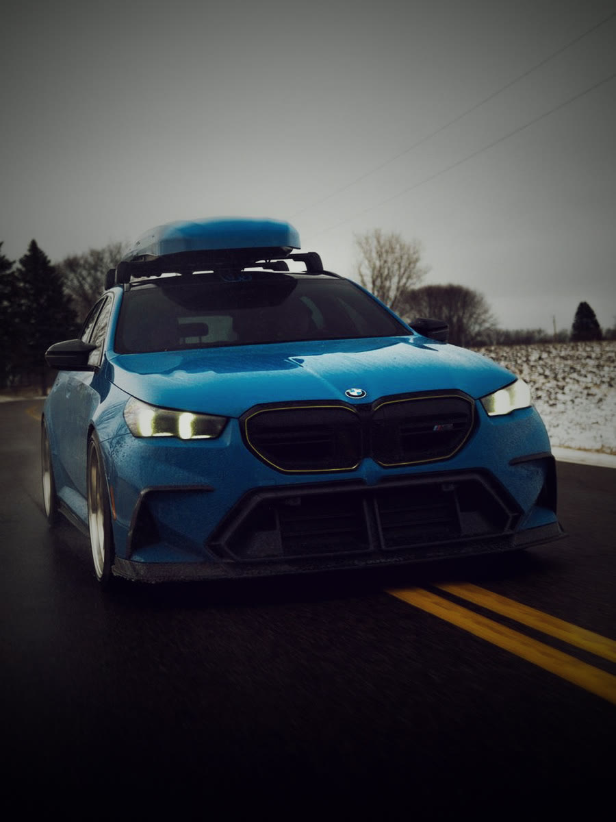 Blue BMW M5 rolling shot, slammed
